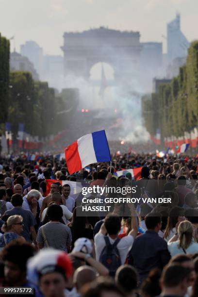 France supporters celebrate on the Champs-Elysees avenue in Paris on July 15 after France won the Russia 2018 World Cup final football match between...