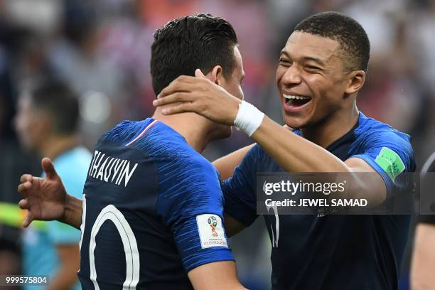 France's forward Kylian Mbappe celebrates with France's forward Florian Thauvin at the end of the Russia 2018 World Cup final football match between...