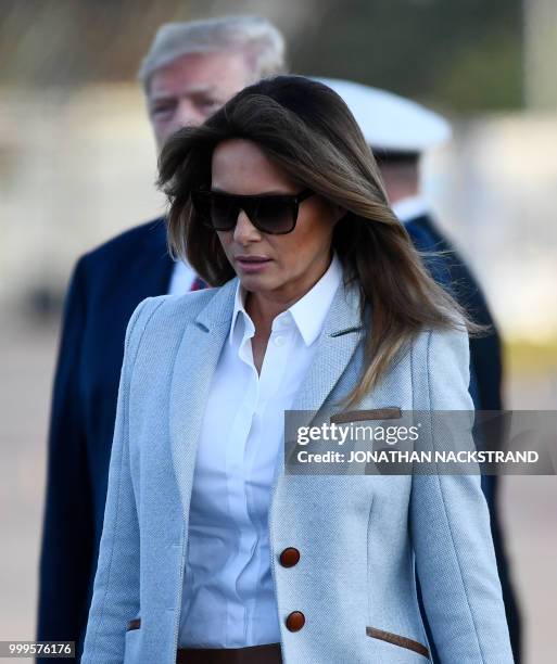 President Donald Trump and US First Lady Melania Trump walk towards the presidential car upon arrival at Helsinki-Vantaa Airport in Helsinki, on July...