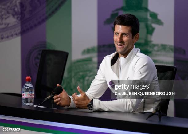 Serbia's Novak Djokovic takes part in a press conference following his men's singles victory on the thirteenth day of the 2018 Wimbledon...