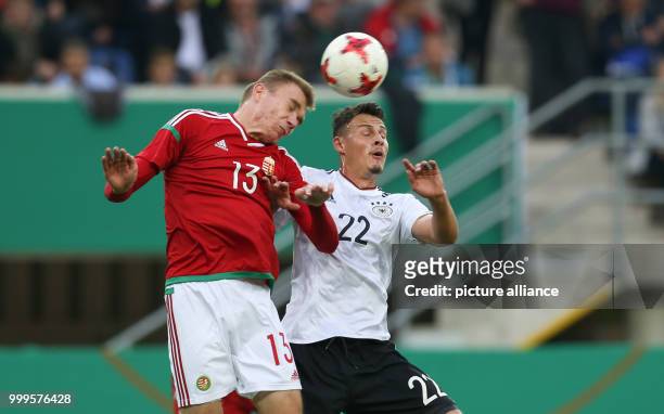 Germany's Janni Serra and Hungary's Attila Szalai vie for the ball during the Under 21 test match between Germany and Hungary in the Benteler Arena...