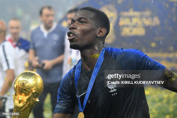 France's midfielder Paul Pogba celebrates with the trophy at the end of the Russia 2018 World Cup final football match between France and Croatia at...