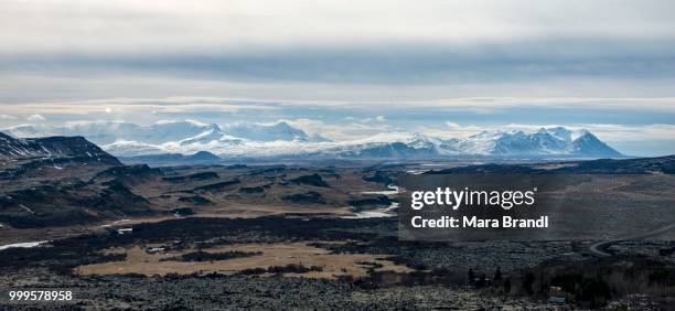 snow-covered mountains in front of volcanic landscape, vesturland, iceland - islande du centre ouest photos et images de collection