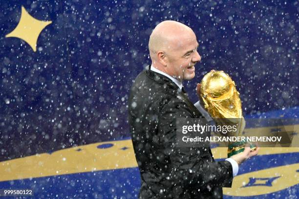 President Gianni Infantino holds the trophy during the trophy ceremony after winning the end of the Russia 2018 World Cup final football match...