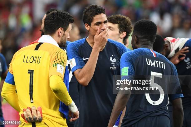 France's goalkeeper Hugo Lloris, France's defender Raphael Varane and France's defender Samuel Umtiti celebrate at the end of the Russia 2018 World...
