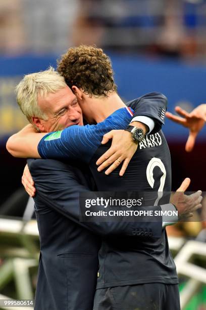 France's coach Didier Deschamps celebrates his team's victory with France's defender Benjamin Pavard at the end of the Russia 2018 World Cup final...