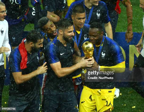 France v Croatia - FIFA World Cup Russia 2018 Final Olivier Giroud and Steve Mandanda kiss the trophy at Luzhniki Stadium in Russia on July 15, 2018.