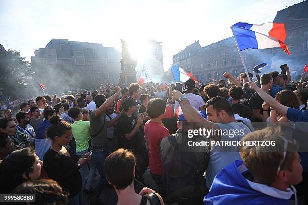 Peopler wave French national flags after France won the Russia 2018 World Cup final football match between France and Croatia, on July 15, 2018 in...