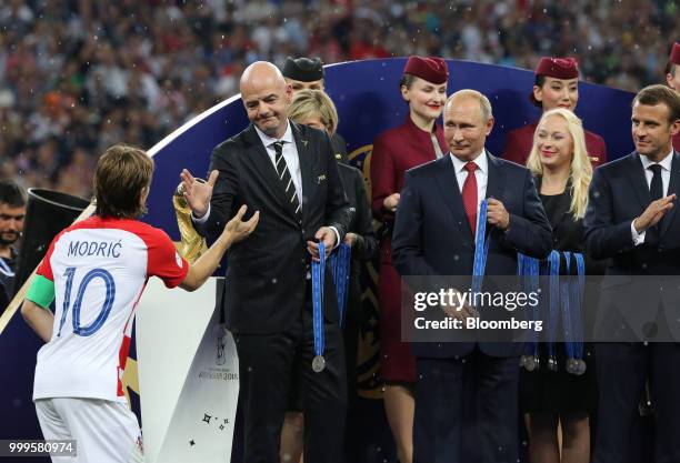 Luka Modric of Croatia, from left, shakes hands with Gianni Infantino, president of FIFA, as Vladimir Putin, Russia's president, and Emmanuel Macron,...