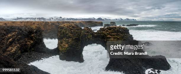 gat velcro, rock arch in the sea, waves at the sea, bad weather, west iceland, iceland - west central iceland stock pictures, royalty-free photos & images