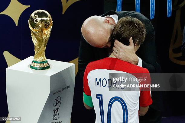 President Gianni Infantino speaks with Croatia's midfielder Luka Modric after the Russia 2018 World Cup final football match between France and...