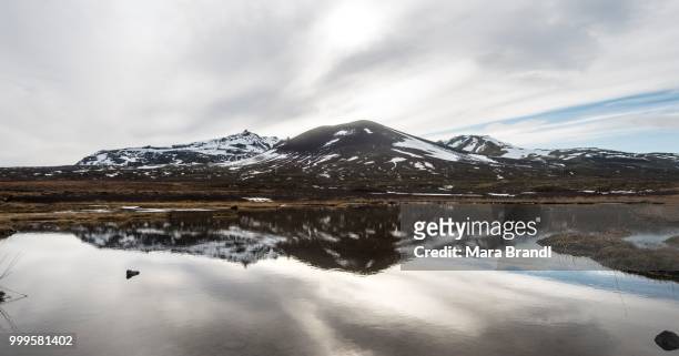 mountains covered with snow are reflected in a small lake, snaefellsnes peninsula, west iceland, iceland - west central iceland stock pictures, royalty-free photos & images