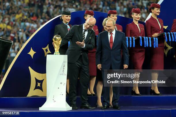 President Gianni Infantino shows off the trophy to Russian President Vladimir Putin before the ceremony at the end of the 2018 FIFA World Cup Russia...