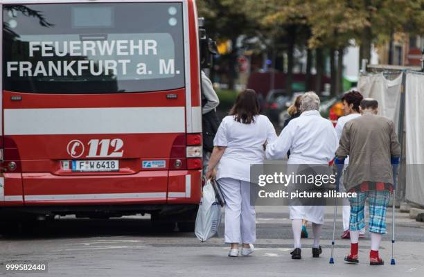 Patients of the Buergerhospital in Frankfurt am Main, Germany, on 02 September 2017, are accompanied to to a large patient transport ambulance in...