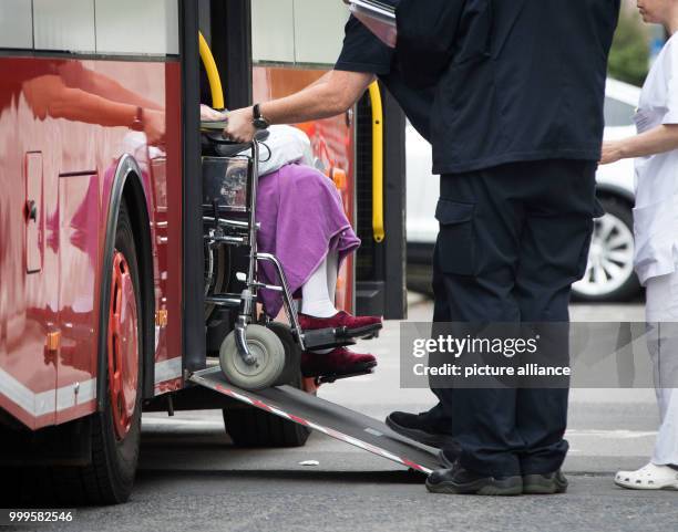 Patient of the Buergerhospital in Frankfurt am Main, Germany, 02 September 2017, is pushed in a wheelchair into a large patient transport ambulance...