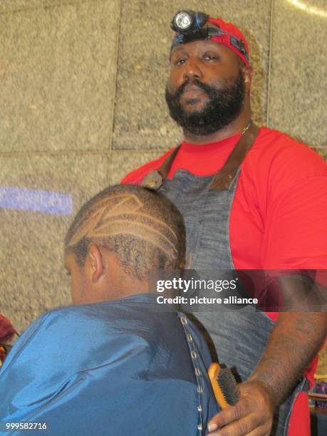 Young man getting his hair cut by a volunteer barber at the George R. Brown Convention Center in Houston, USA, 01 September 2017. One week after the...