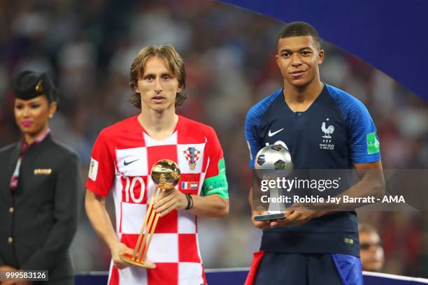 Luka Modric of Croatia poses with the FIFA Golden Ball for player of the tournament and Kylian Mbappe of France the silver ball for best young player...