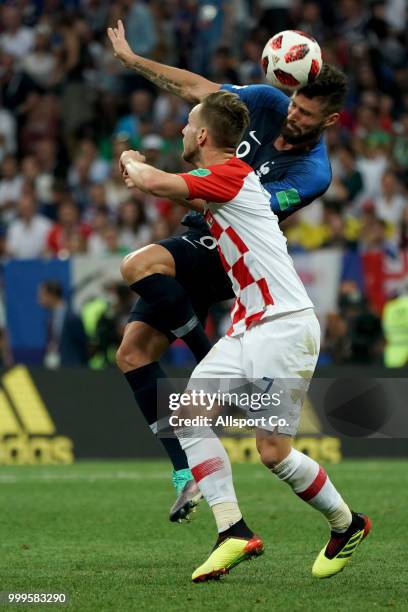 Olivier Giroud of France competes for the ball with Ivan Rakitic of Croatia during the 2018 FIFA World Cup Russia Final between France and Croatia at...