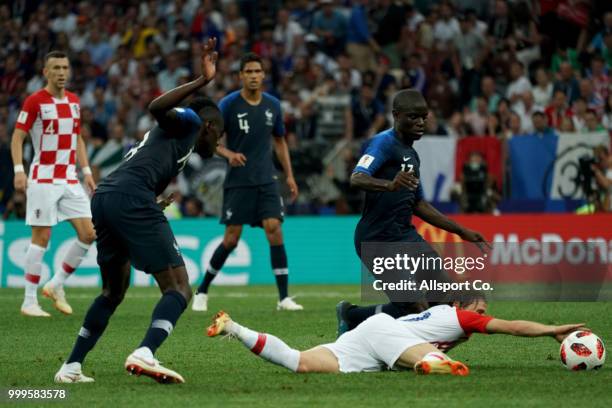 Ngolo Kante of France battles Luka Modric of Croatia during the 2018 FIFA World Cup Russia Final between France and Croatia at Luzhniki Stadium on...
