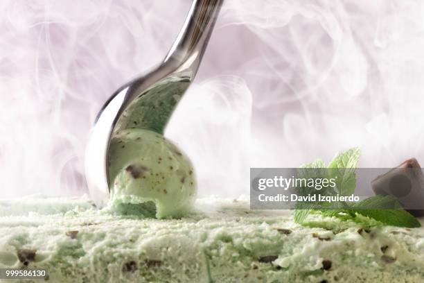 making a mint choco ice cream with scoop front view - mint ice cream stock pictures, royalty-free photos & images