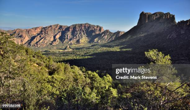 taking in the full breadth of the chisos mountains and basin below - chisos mountains stock pictures, royalty-free photos & images