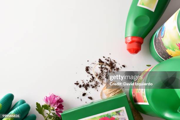 bottles and containers gardening products on white table top vie - vie stock-fotos und bilder