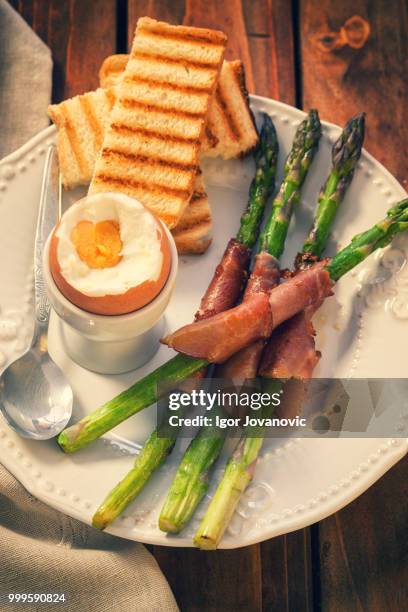organic asparagus wrapped in prosciutto - prosciutto wrapped stock pictures, royalty-free photos & images