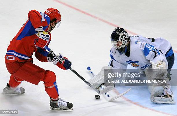 Artyom Anisimov of NHL's New York Rangers attacks Finland's goalie Petri Vehanen during a qualification round match of the IIHF International Ice...