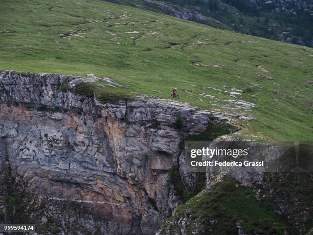 man on motocross along steep ridge of monte teggiolo - fmx stock pictures, royalty-free photos & images