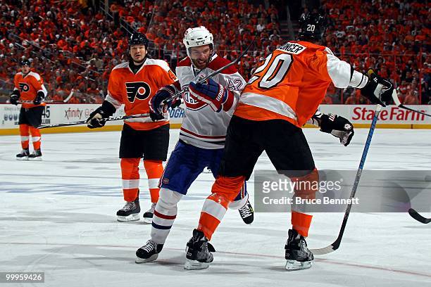 Dominic Moore of the Montreal Canadiens skates against Chris Pronger of the Philadelphia Flyers in Game 1 of the Eastern Conference Finals during the...