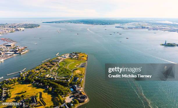 aerial view of the governors island, ny with the statue of liberty in the background - governors stock pictures, royalty-free photos & images