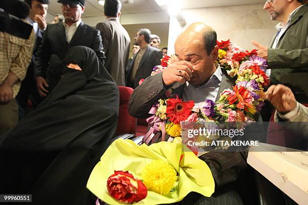 Iranian agent Ali Vakili Rad and his mother arrive at Imam Khomeini Airport in Tehran, on May 18, 2010 after his release from a French prison where...