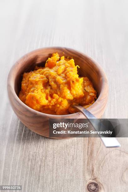 pumpkin puree with a spoon on a wooden surface - vegetable curry stock pictures, royalty-free photos & images