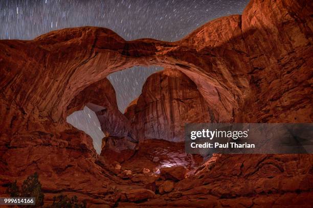 starry trail at the double arch - double arch stock pictures, royalty-free photos & images