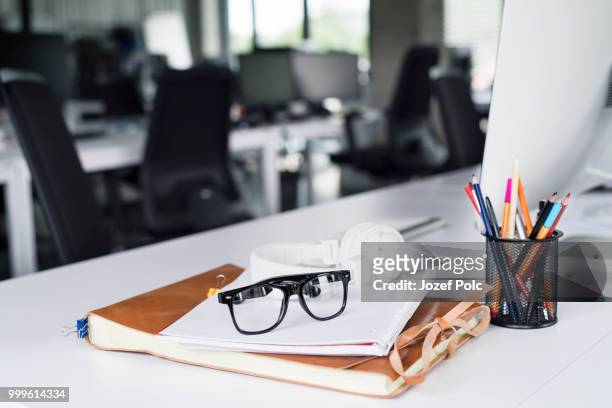 office desk with computer, notebook and eyeglasses. - jozef polc stock pictures, royalty-free photos & images