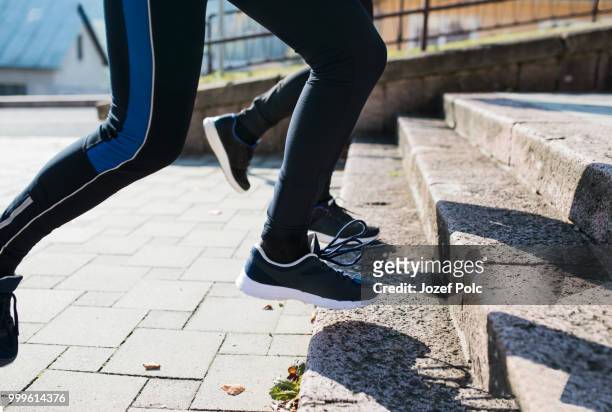 unrecognizable athletes running on stairs on sunny autumn day. - jozef polc stock pictures, royalty-free photos & images