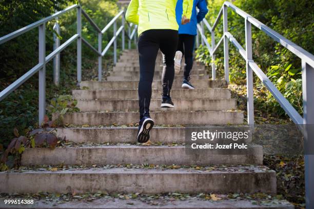 unrecognizable athletes running on stairs on sunny autumn day. - jozef polc stock pictures, royalty-free photos & images