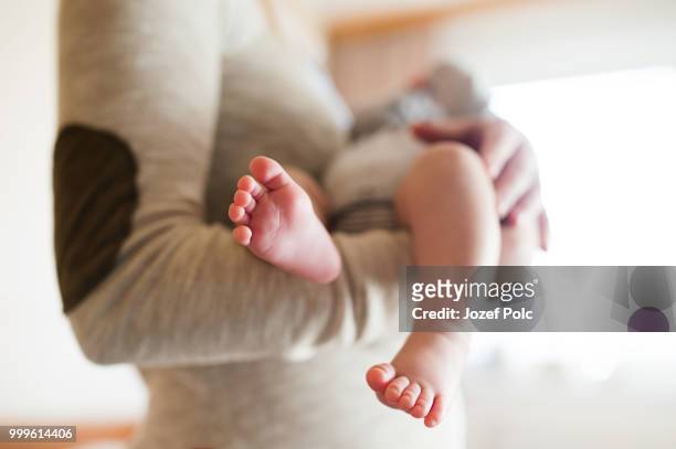 unrecognizable mother with newborn baby son, legs and hands - jozef polc stock pictures, royalty-free photos & images