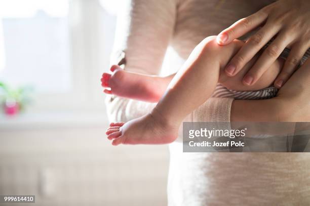 unrecognizable mother with newborn baby son, legs and hands - jozef polc stock pictures, royalty-free photos & images