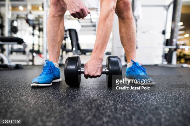unrecognizable senior man in gym working out with weights - jozef polc stock pictures, royalty-free photos & images