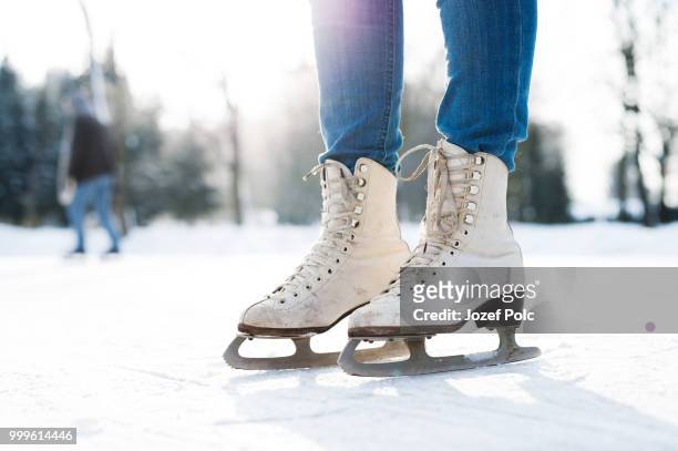 legs of unrecognizable woman ice skating outdoors, close up. - jozef polc stock pictures, royalty-free photos & images
