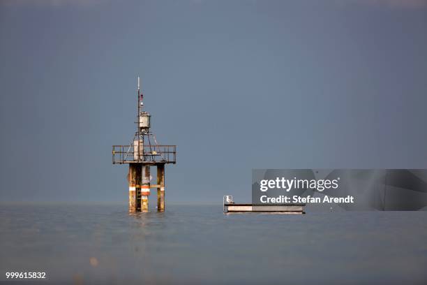 lighthouse and a floating island in stormy atmosphere over lake constance in konstanz, baden-wuerttemberg, germany - floating island stock pictures, royalty-free photos & images