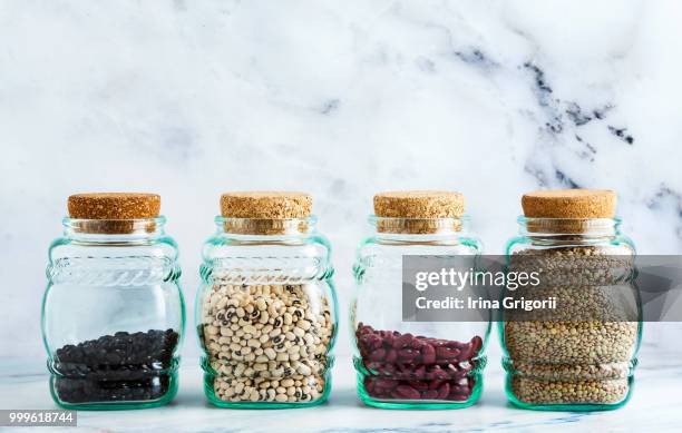 different types of legumes in glass jars with cork lids on a mar - cork material bildbanksfoton och bilder