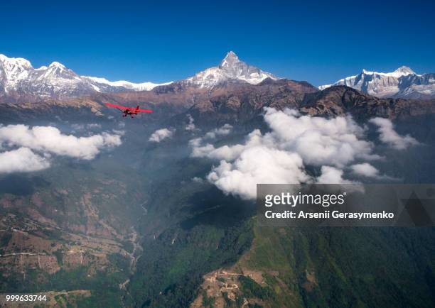 plane over annapurna region and machapuchare - machapuchare stock pictures, royalty-free photos & images