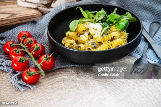 radiatori pasta in a creamy tomato parmesan cheese sauce - tomato pasta stock pictures, royalty-free photos & images