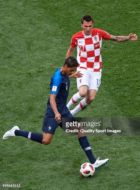 Raphael Varane of France competes for the ball with Mario Mandzukic of Croatia during the 2018 FIFA World Cup Russia Final between France and Croatia...