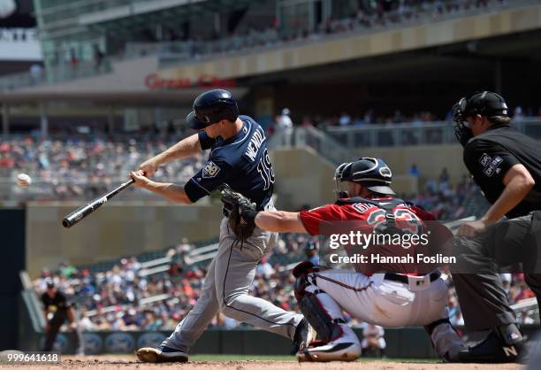Joey Wendle of the Tampa Bay Rays hits an RBI single as Mitch Garver of the Minnesota Twins catches during the fifth inning of the game on July 15,...
