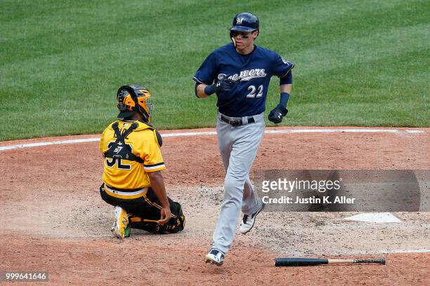 Christian Yelich of the Milwaukee Brewers scores on a RBI single in the sixth inning against the Pittsburgh Pirates at PNC Park on July 15, 2018 in...