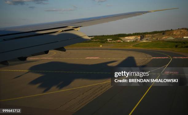 The shadow of the Air Force One carrying the US President is seen on the tarmac upon arrival at Helsinki-Vantaa Airport in Helsinki, on July 15, 2018...