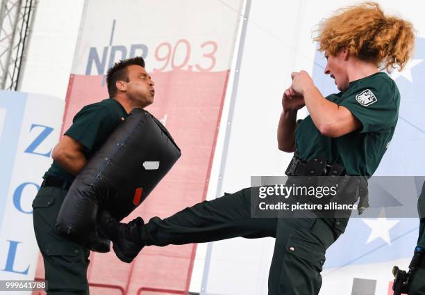 Dpatop - A customs official kicks a pad held by another customs offical during a self defence demonstration as part of Tag des Zolls in Hamburg,...
